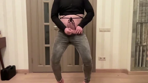 Femboy in grey skinny back zipper jeans, high high-heeled slippers and black flagellated half-top dancing masturbating and cum